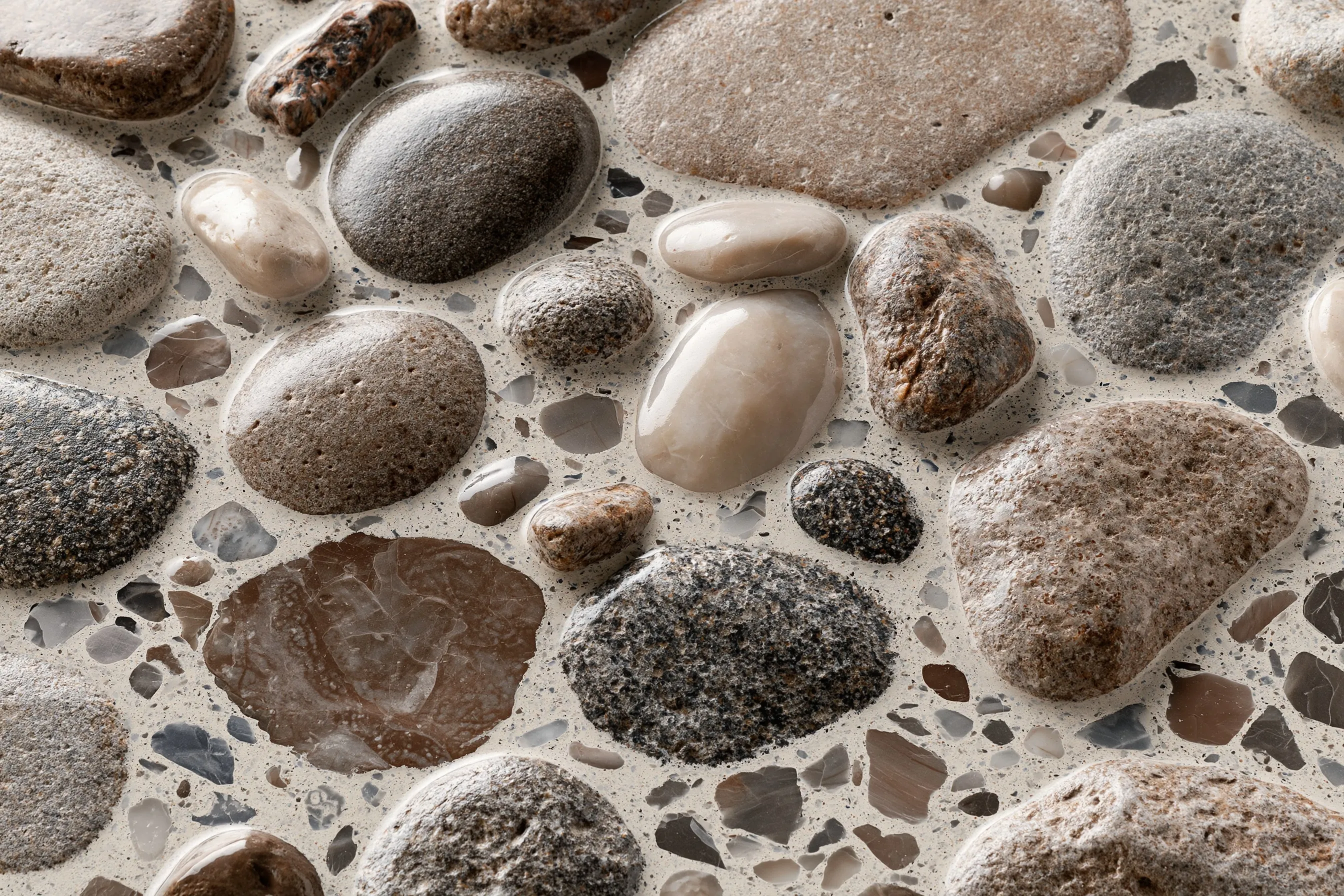 Close-up of full aggregate exposure polished concrete with coarse river-rock stones in a sand paste